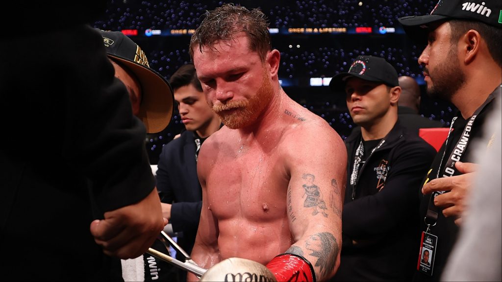 Canelo Alvarez gets the tape cut off his gloves after a loss to Terence Crawford