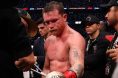 Canelo Alvarez gets the tape cut off his gloves after a loss to Terence Crawford