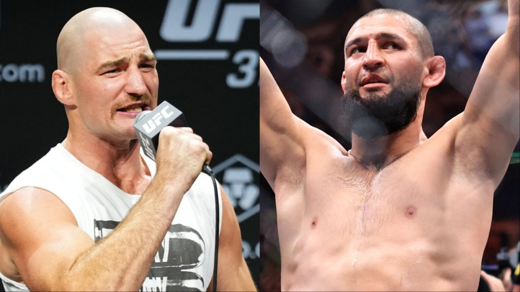 Sean Strickland speaks during the UFC 312 press conference, opposite Khamzat Chimaev celebrating his win at UFC 319
