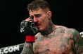 Tom Aspinall reacts after getting poked in the eyes during his fight at UFC 321