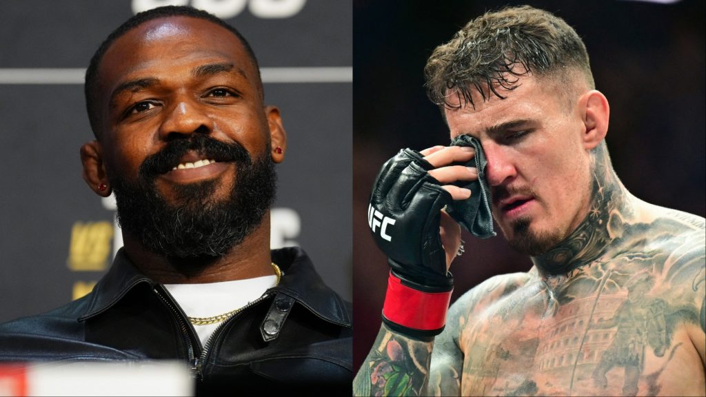 Jon Jones appears at the UFC 309 press conference, opposite Tom Aspinall after an eye poke suffered at UFC 321