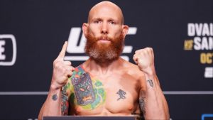 Josh Emmett poses on the scale at the UFC 320 ceremonial weigh-in
