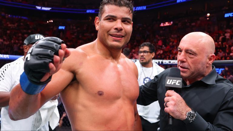 Paulo Costa is interviewed by Joe Rogan in the cage at UFC 327