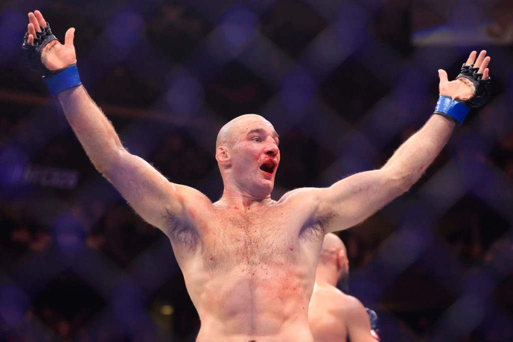 Sean Strickland raises his arms after UFC 328 fight with Khamzat Chimaev